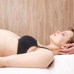 pregnant woman getting chiropractic adjustment
