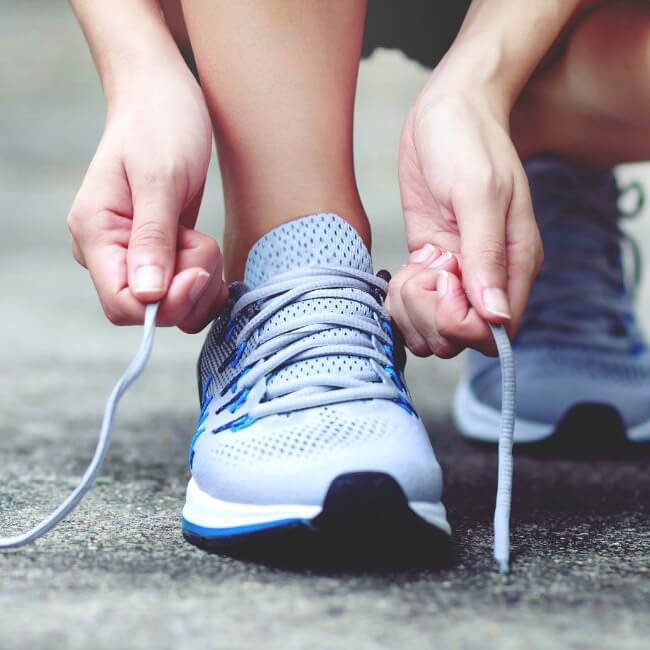 person tying shoes